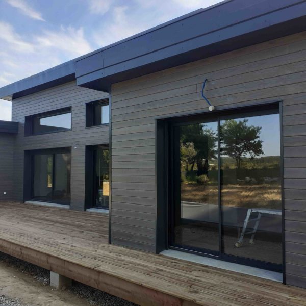 constrction maison en bois avec baies vitrées et fenêtresen alu